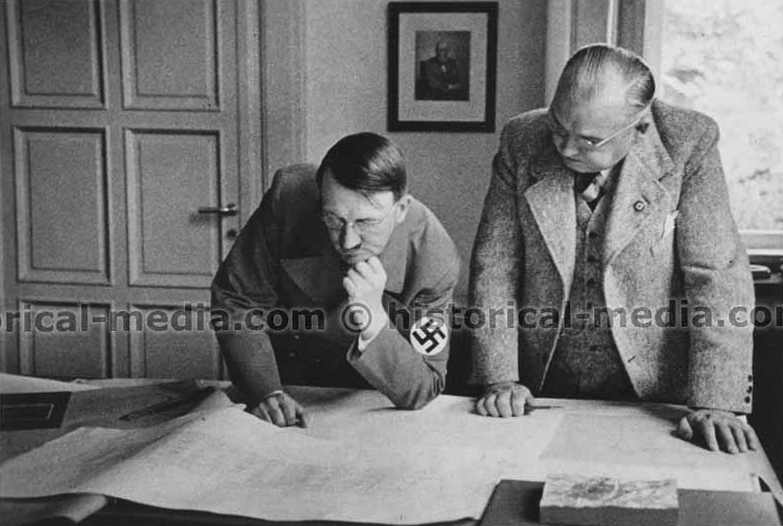 Adolf Hitler during a visit to the atelier of architect Woldemar Brinkmann, he is shown the plans for Munich's opera and Berlin's Reichstag